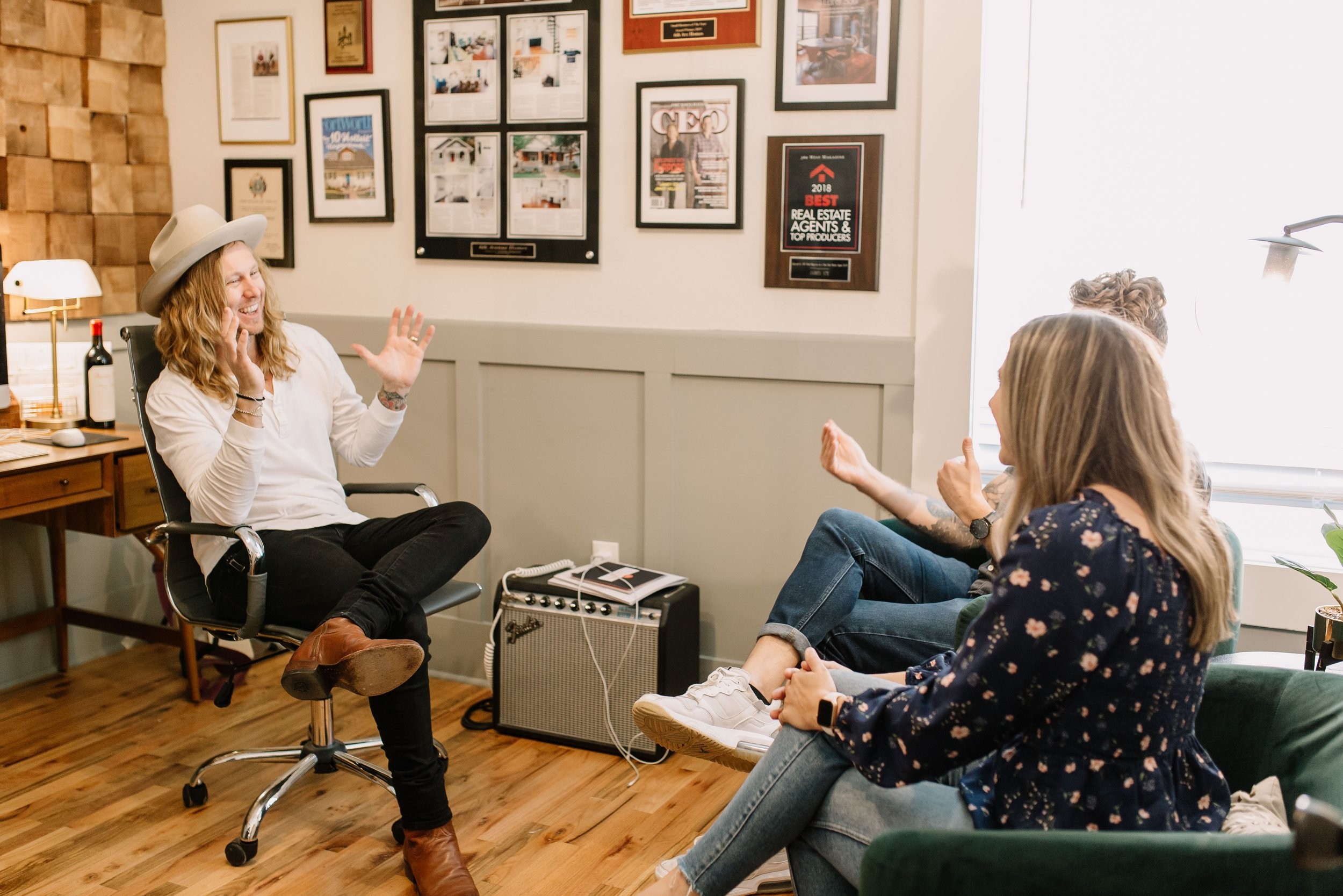 Jamey Ice in his office, coaching two people through a problem