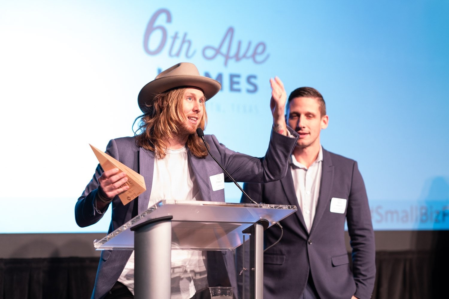 Jamey Ice and Jimmy Williams at a podium accepting the Small Business of the Year award.