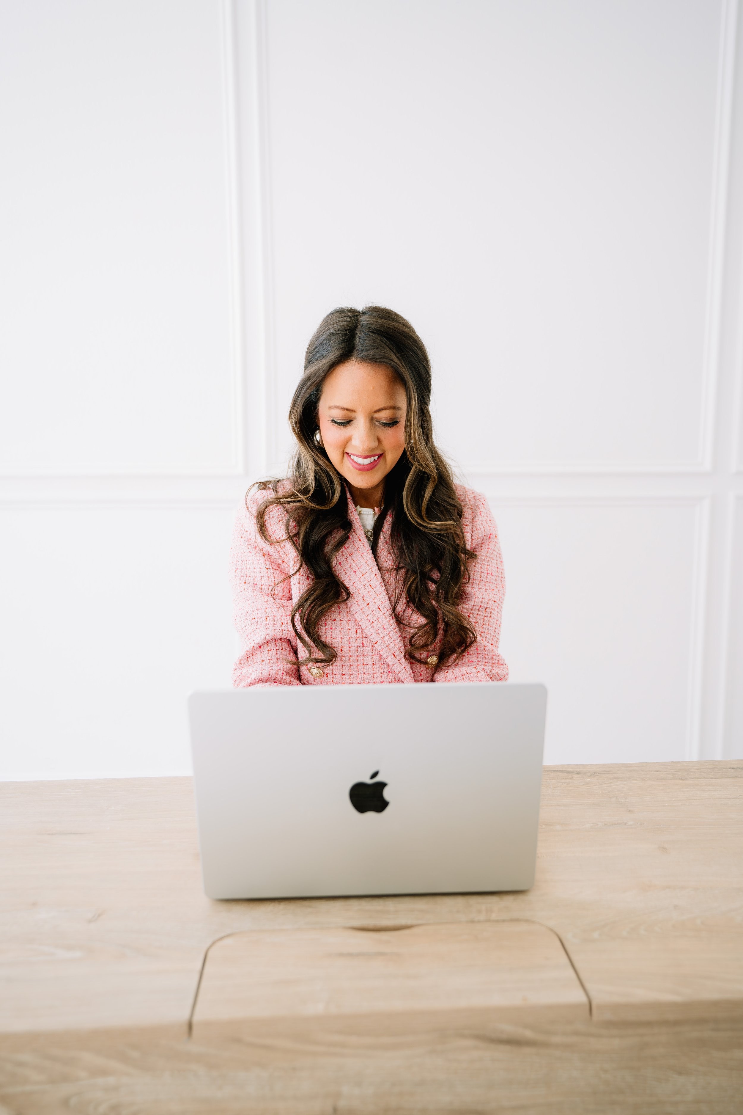 Melissa Ice at a laptop, smiling down at the screen