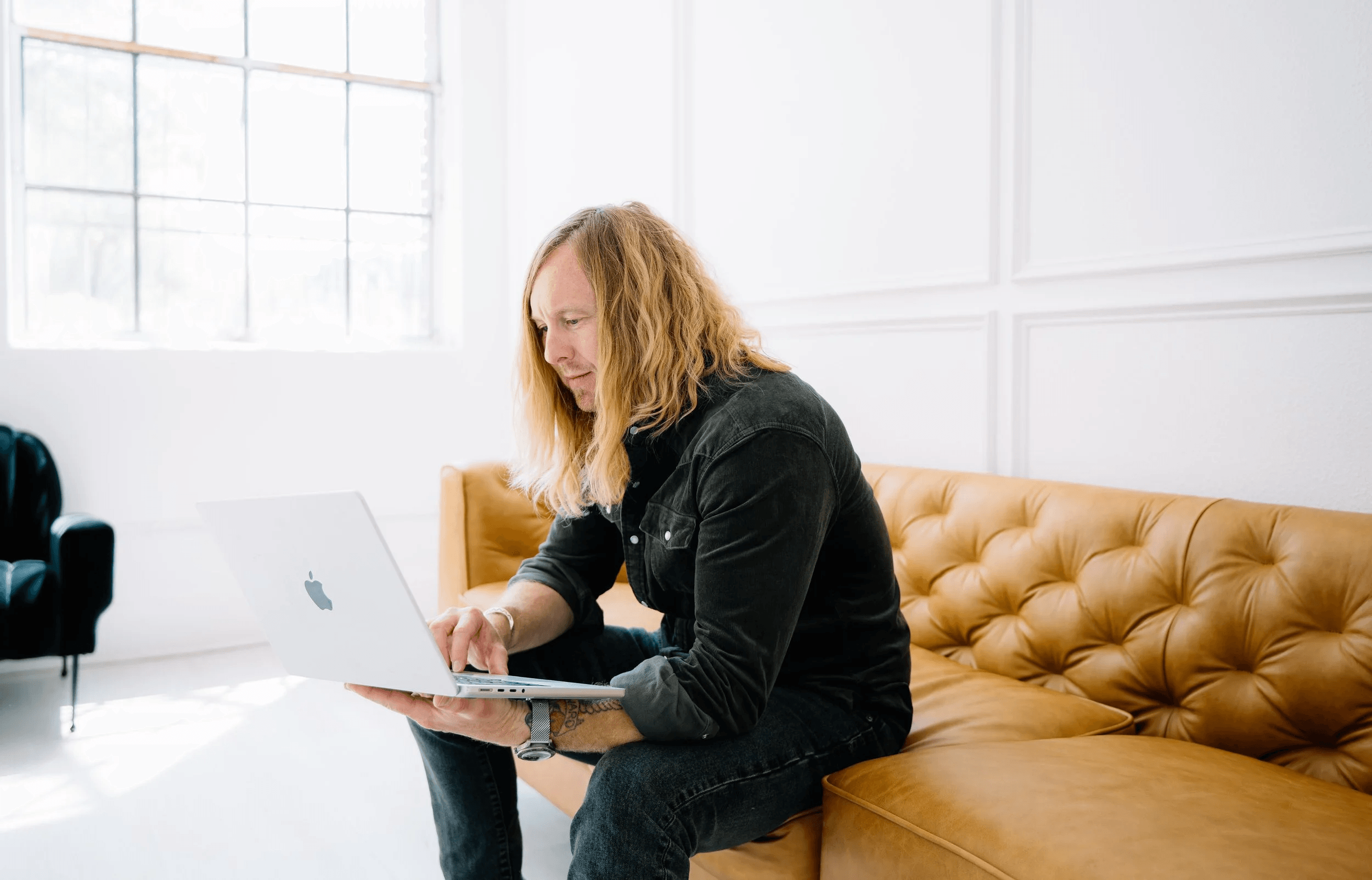 Jamey Ice working at a laptop, window light behind him